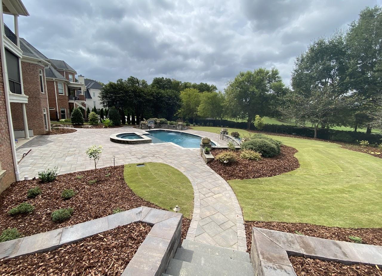 Paver walkway and patio around a backyard pool installed by Toms Creek