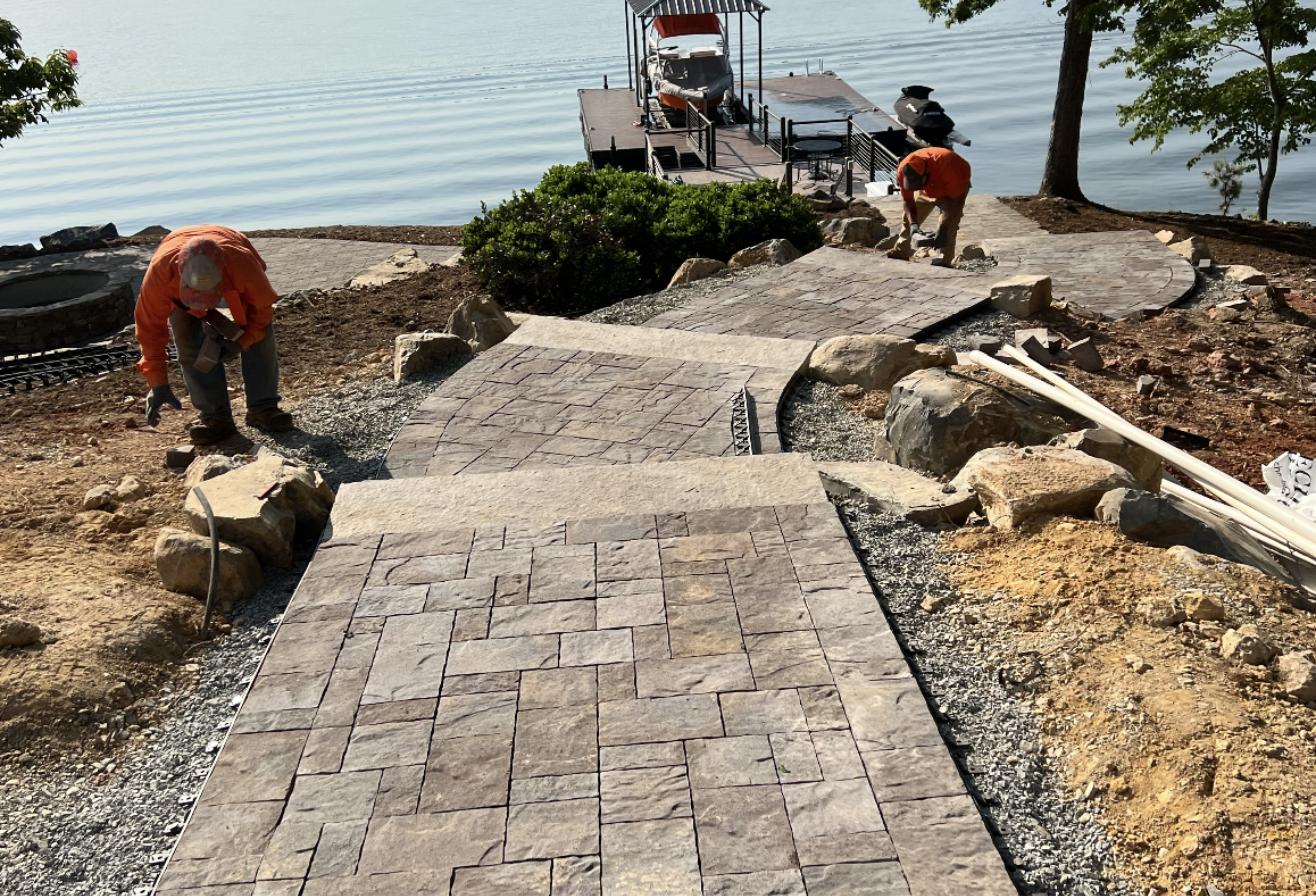 Crew installing a lakefront paver walkway