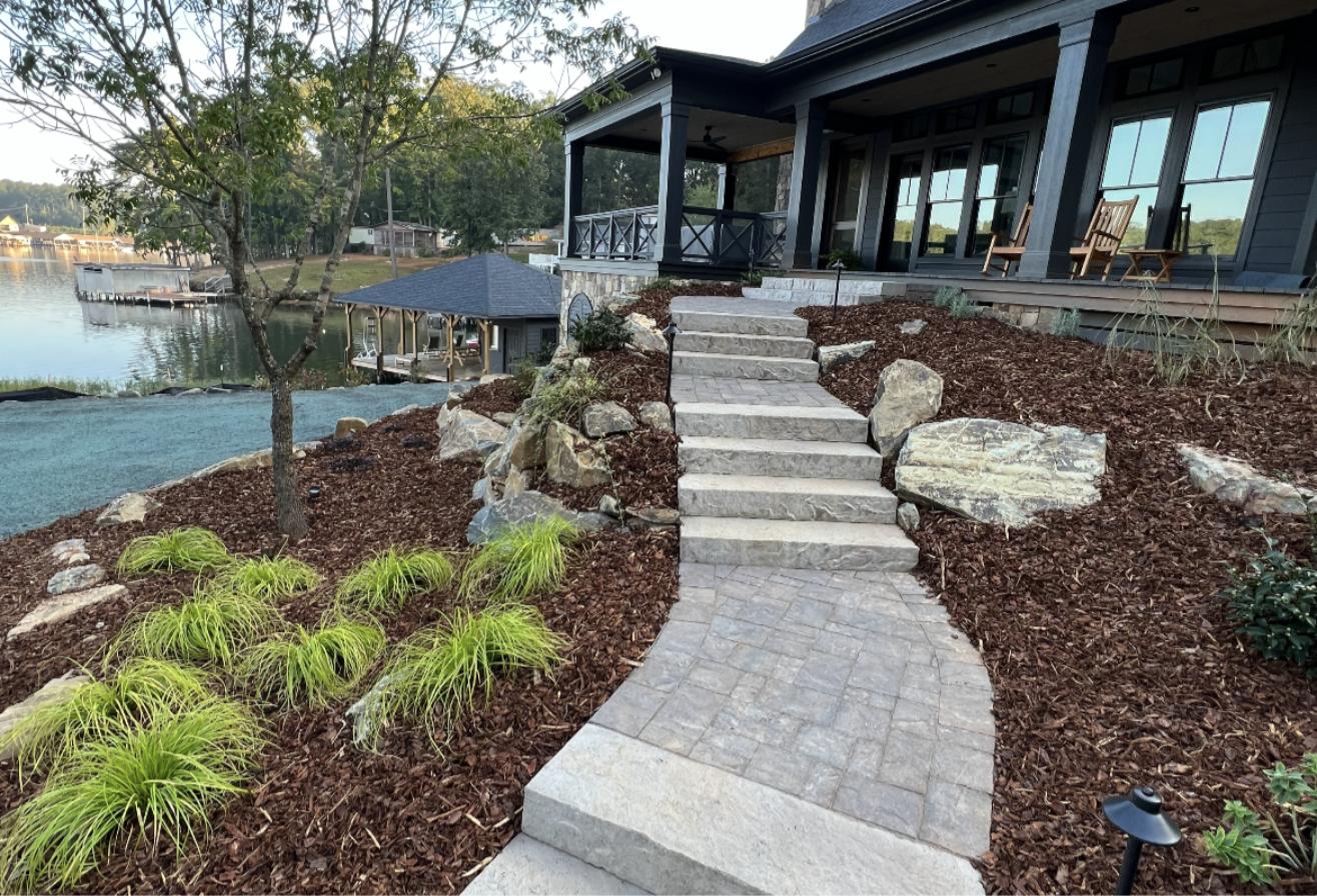 Natural stone steps and paver walkway at a lake house