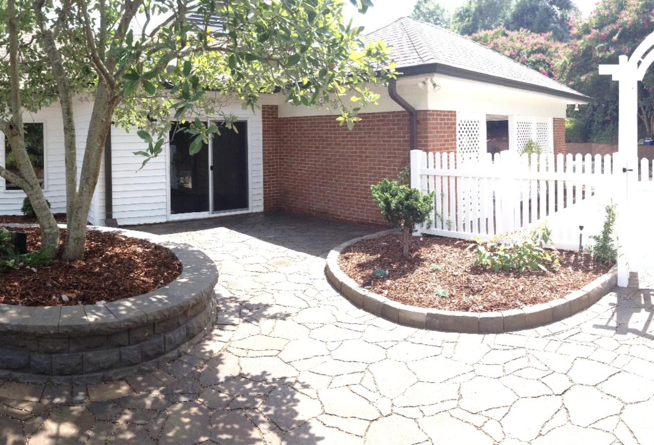Flagstone courtyard patio with paver seat walls and planting beds